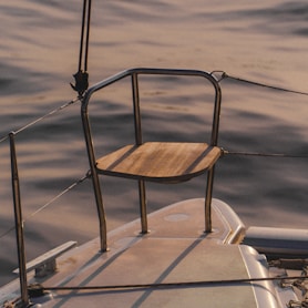 brown wooden chair on white boat during daytime