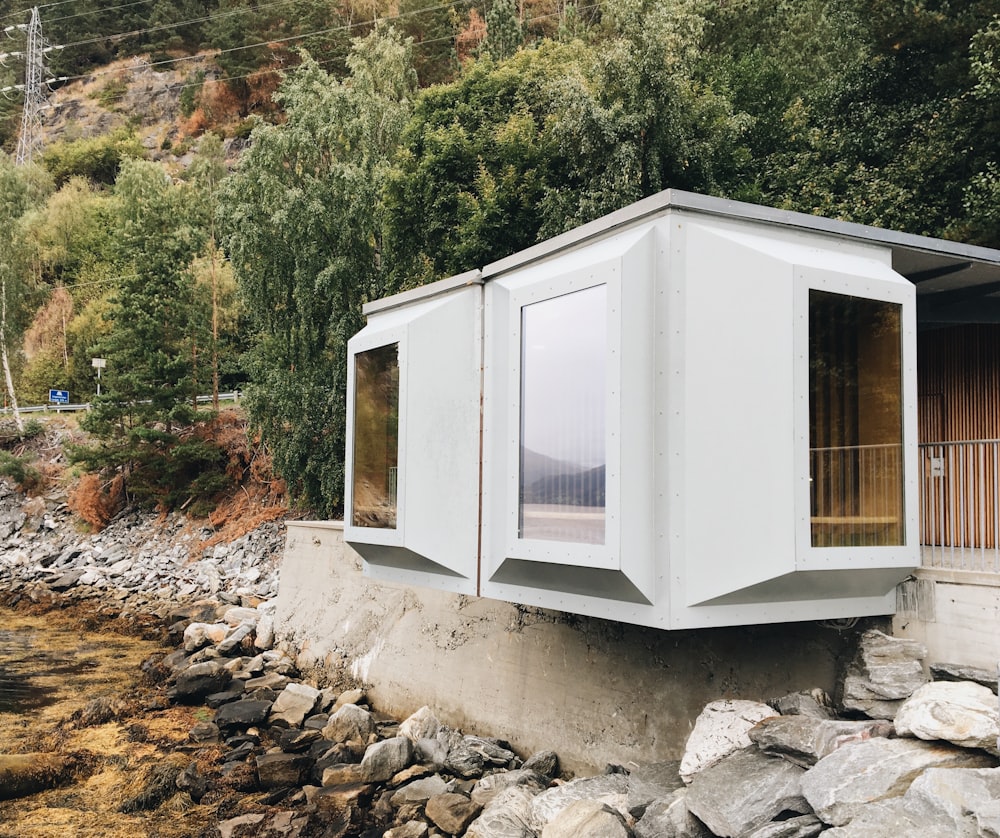 white wooden house on rocky ground