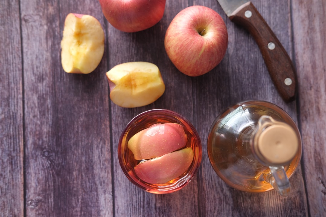 sliced apple beside black handled knife,
