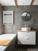 white ceramic bathtub beside white ceramic bathtub