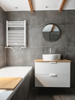 white ceramic bathtub beside white ceramic bathtub