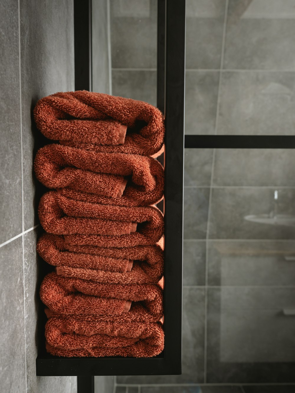 brown towel on white ceramic wall tiles