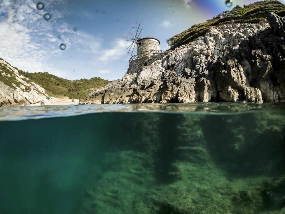 body of water near mountain during daytime