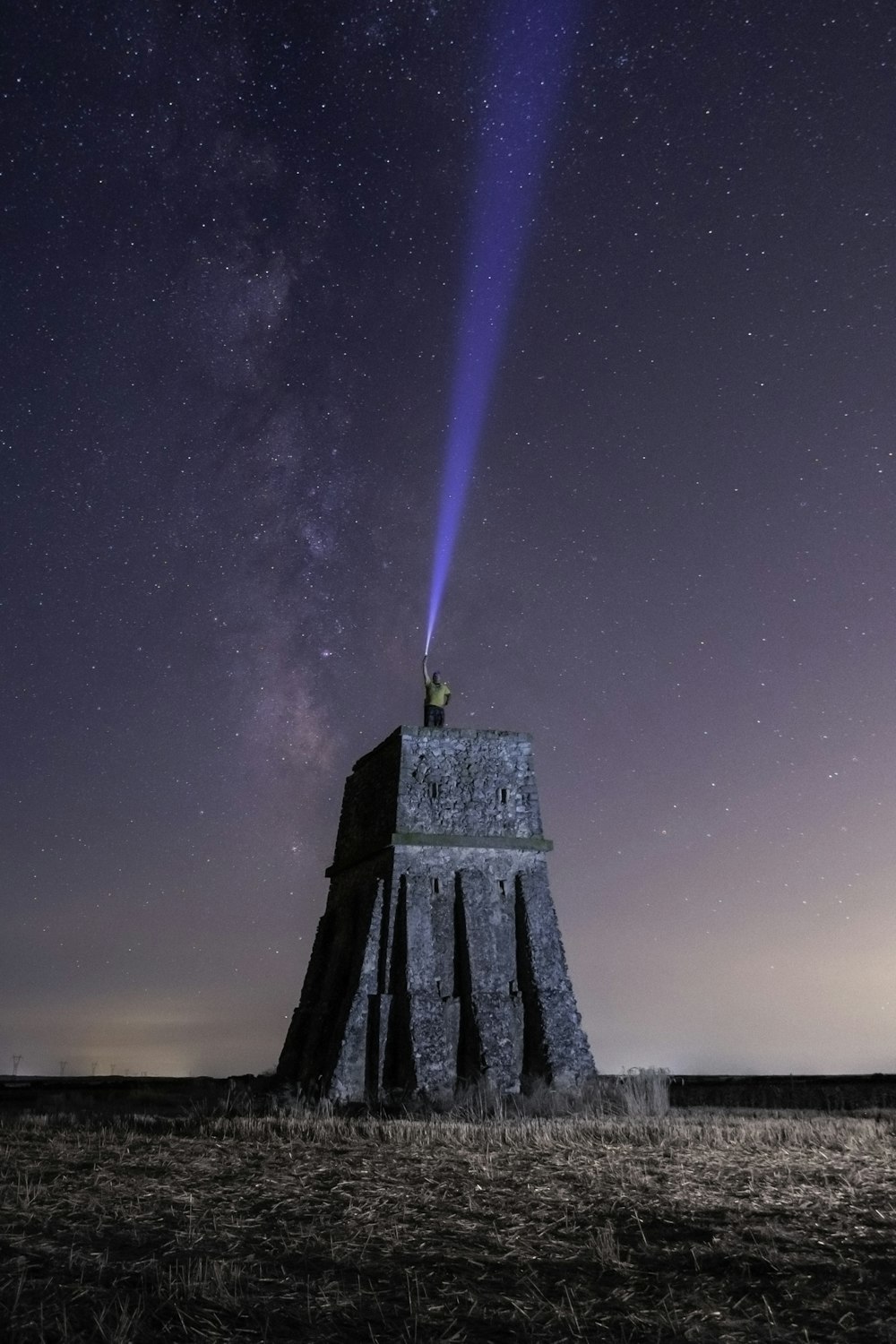 gray concrete tower under starry night