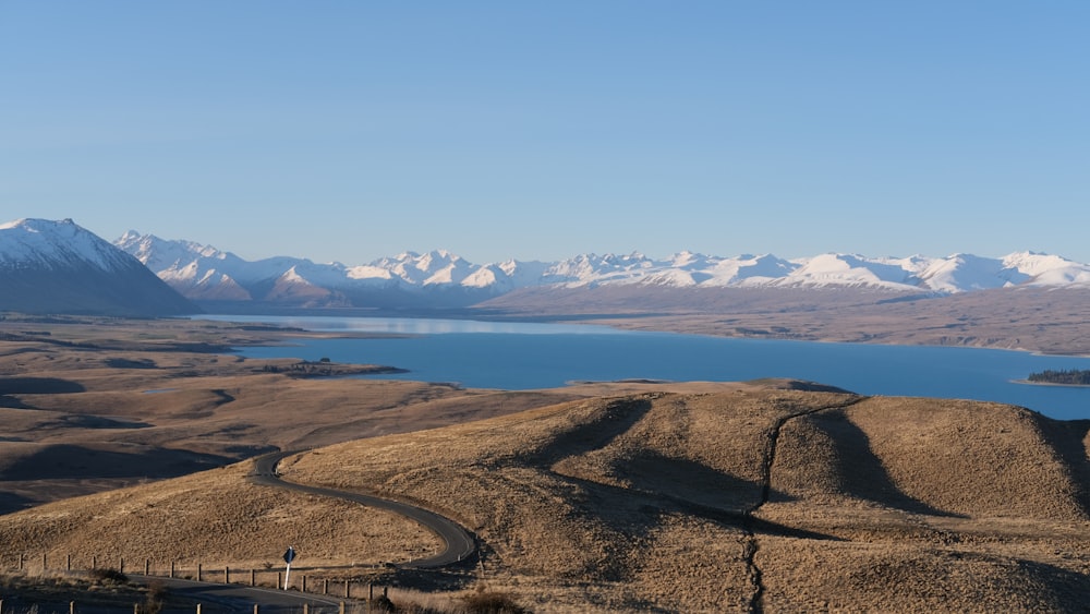 aerial view of brown field near body of water during daytime