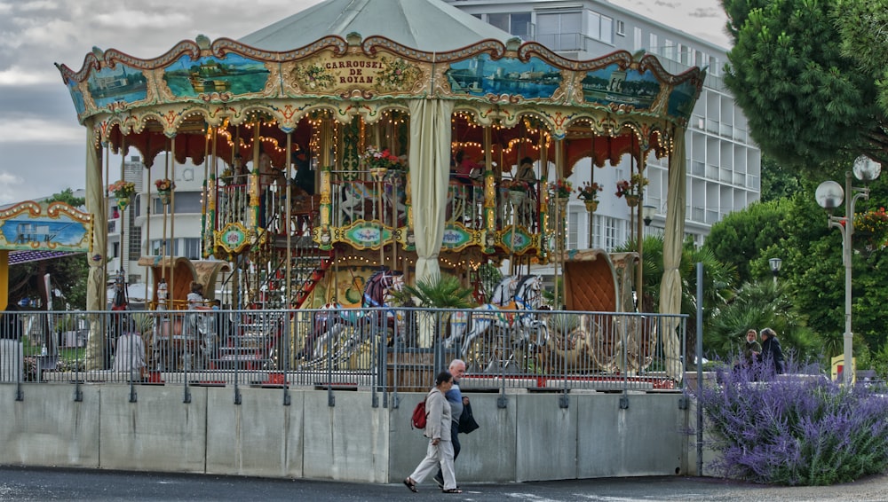people walking on carousel during daytime