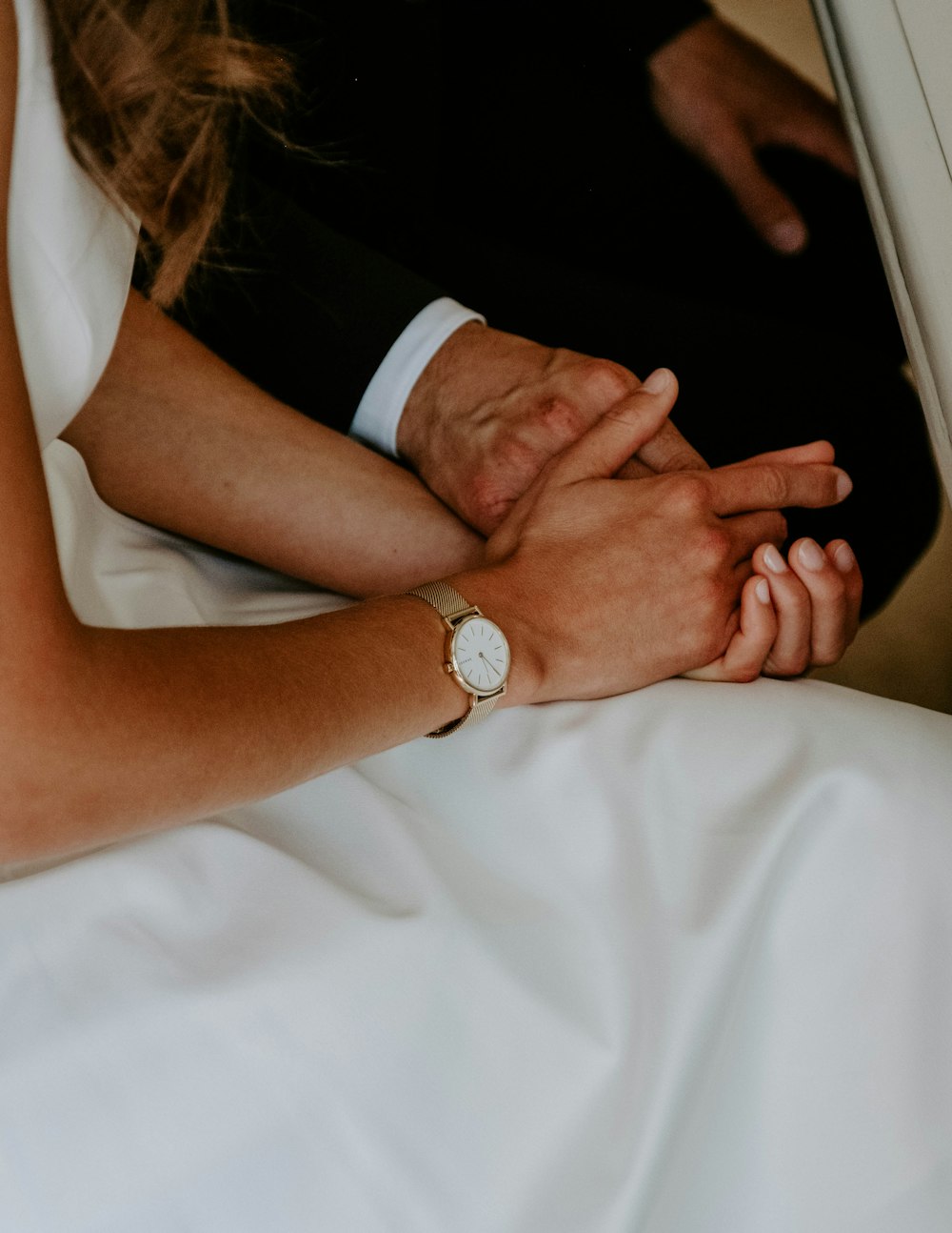 man in black suit and woman in white dress