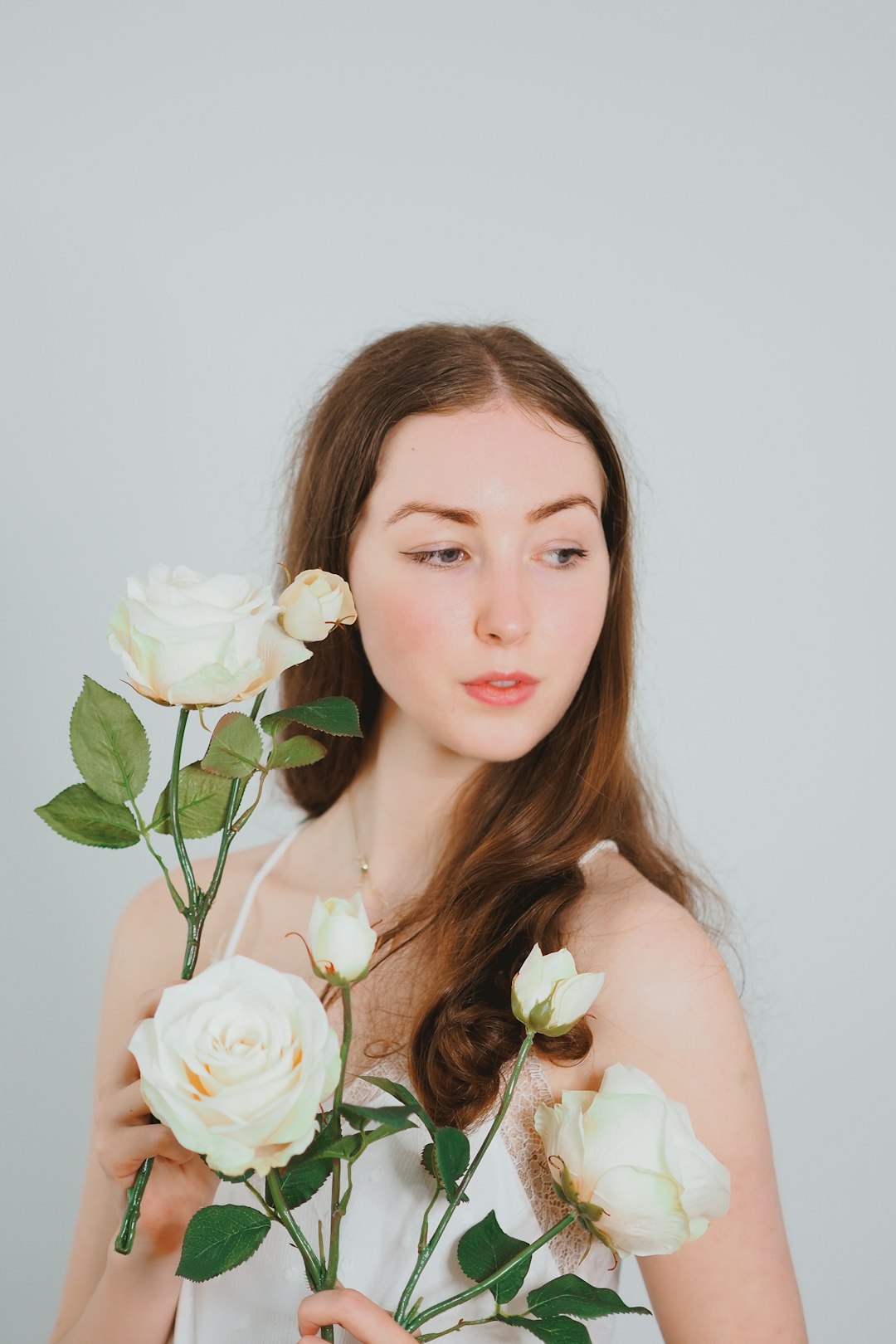 woman holding white rose bouquet