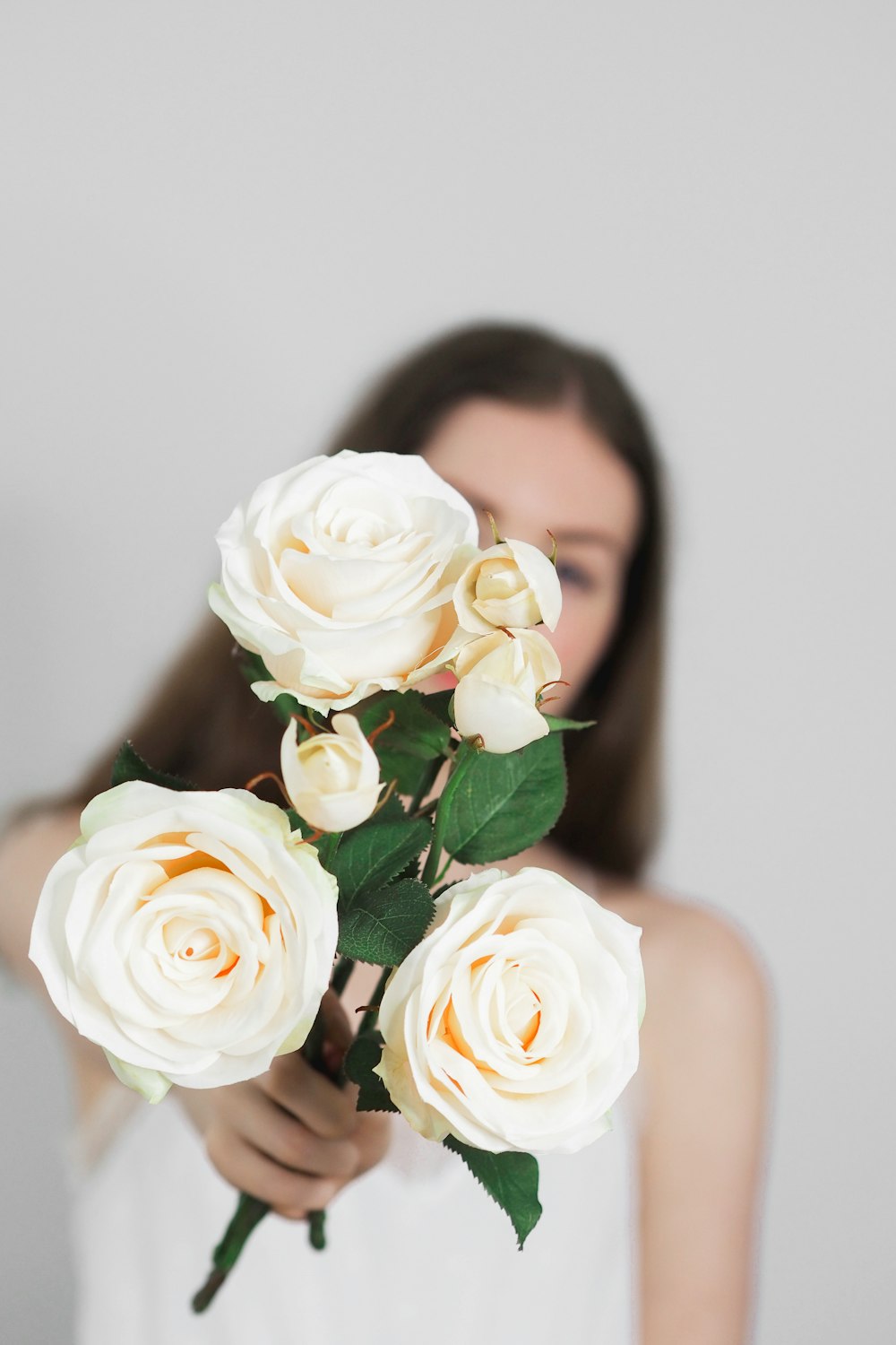 woman holding white rose bouquet