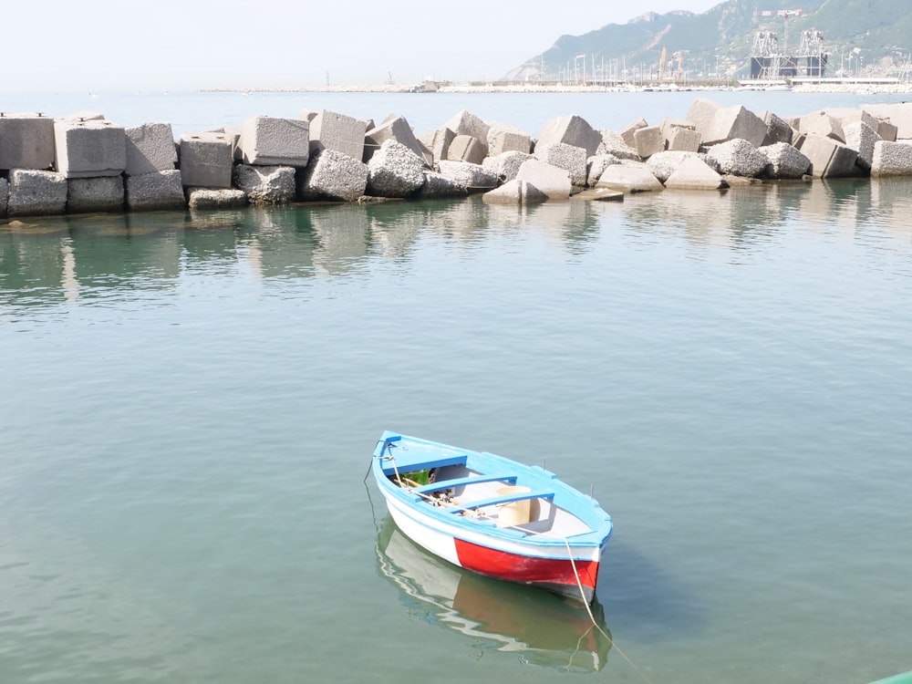 red and white boat on water during daytime