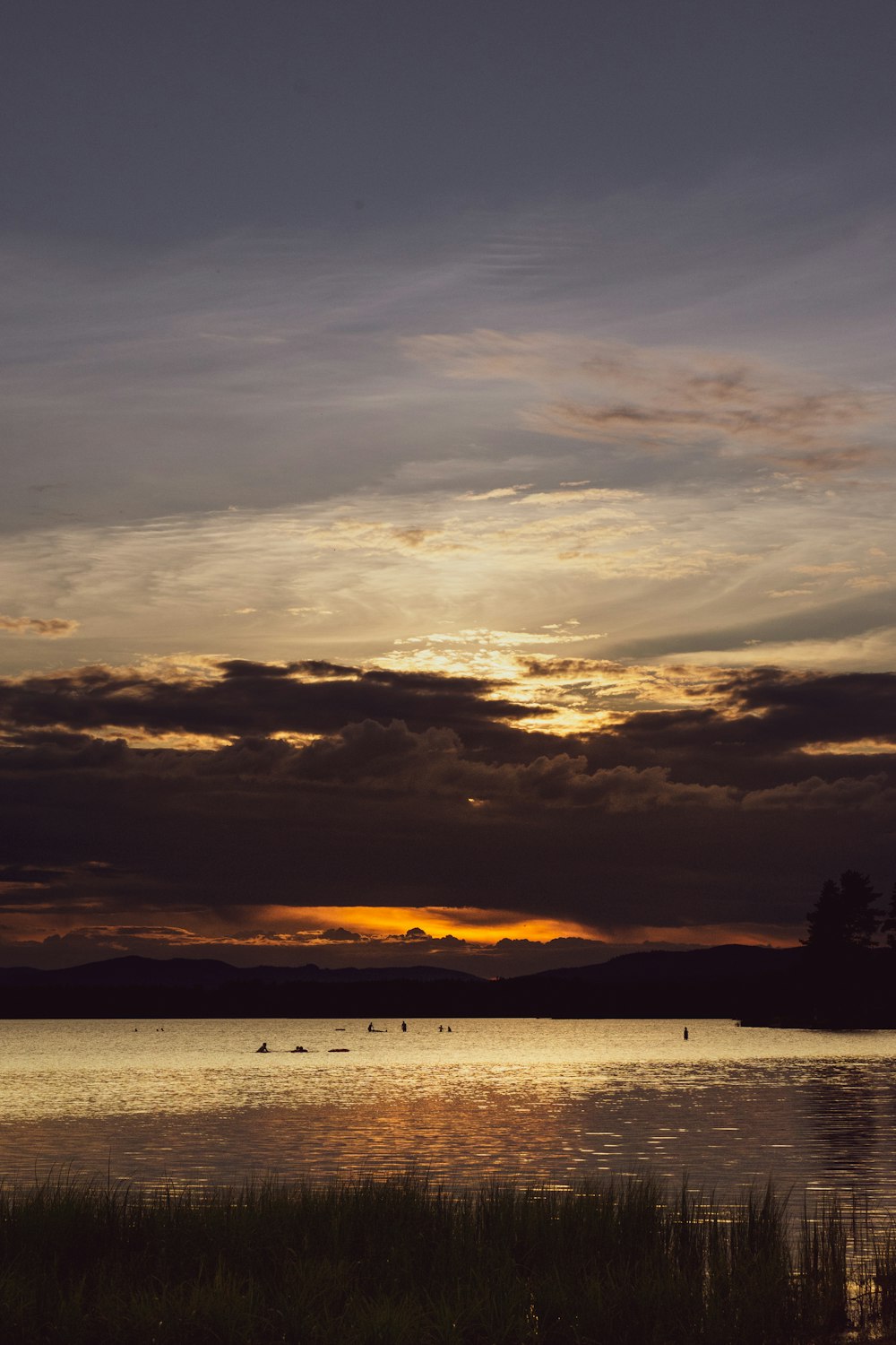 silhouette of boat on sea during sunset