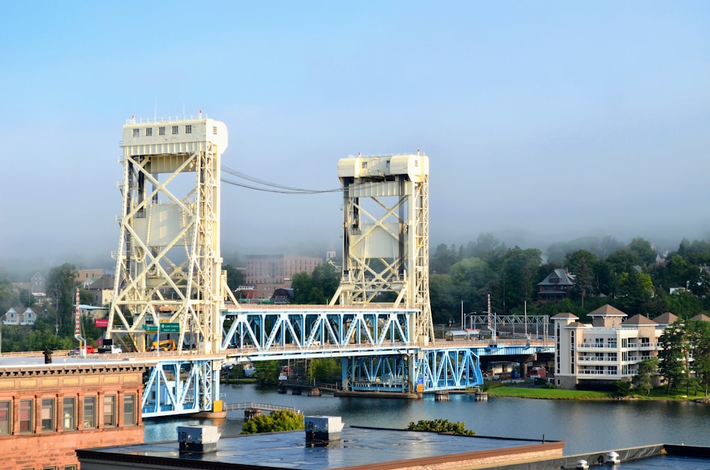 white bridge over river under white sky during daytime