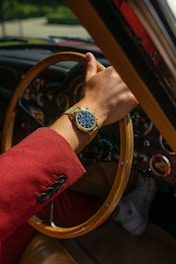 person wearing gold and silver round analog watch