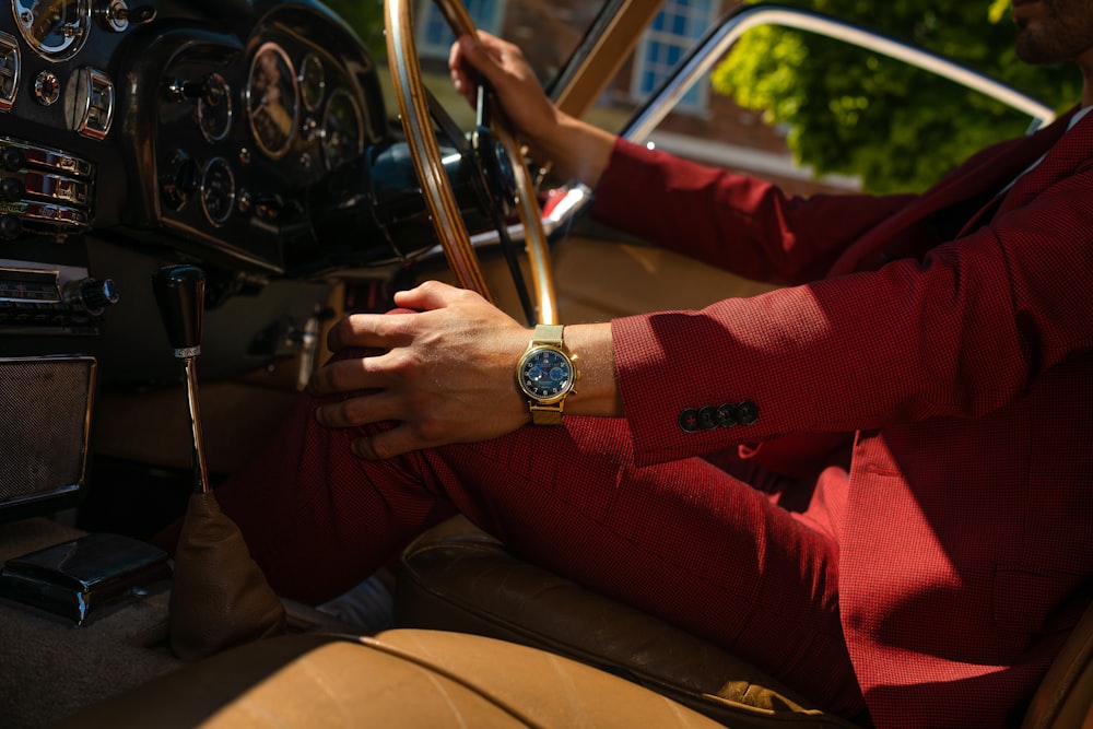 person in red long sleeve shirt driving car