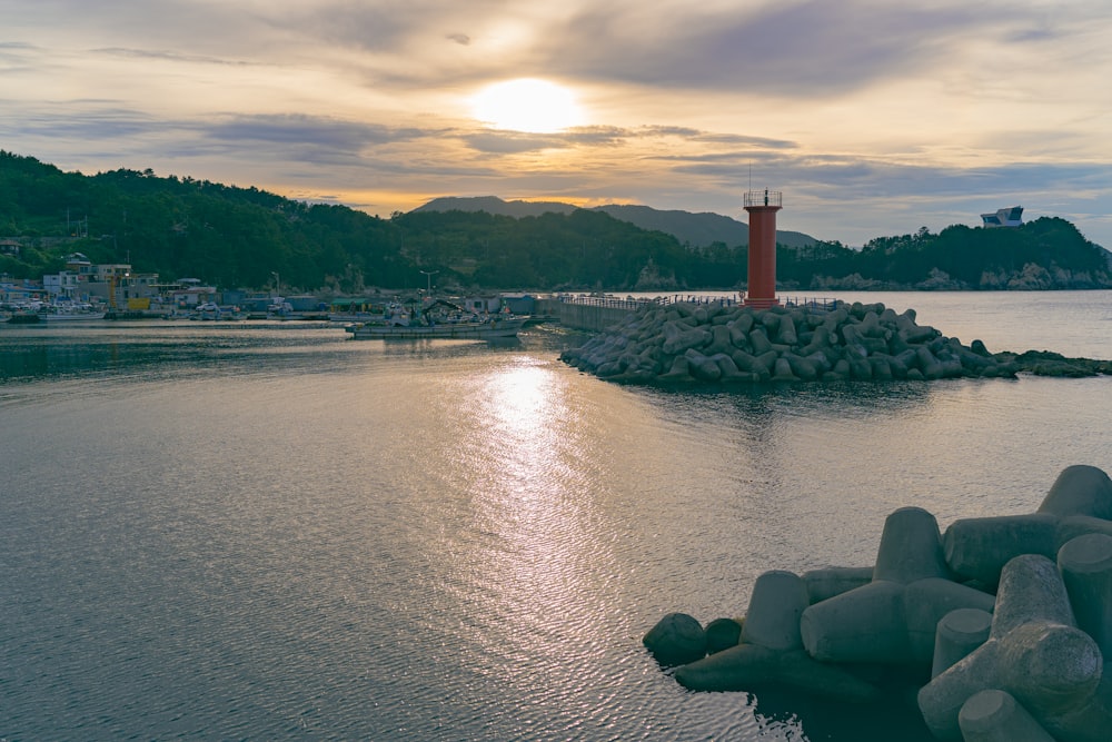 red tower near body of water during daytime