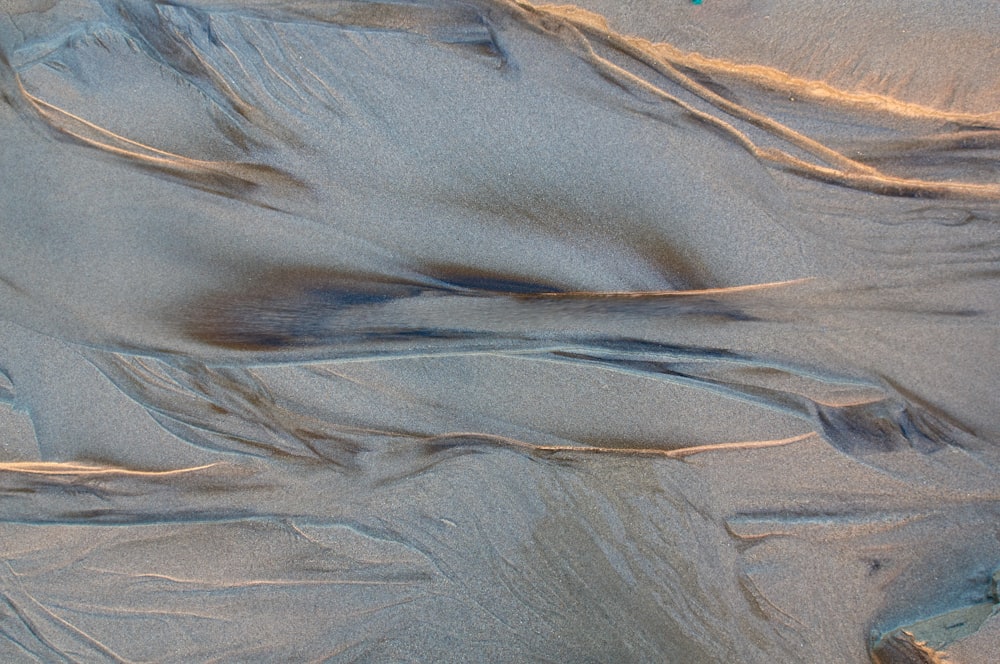 brown sand with footprints during daytime