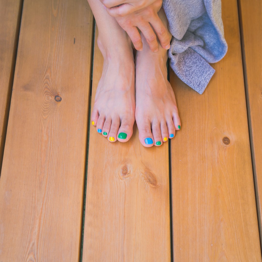 person with orange nail polish