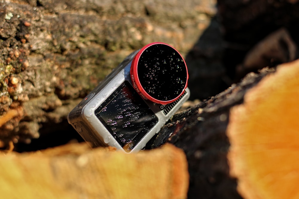 black and red plastic bottle on brown wooden plank