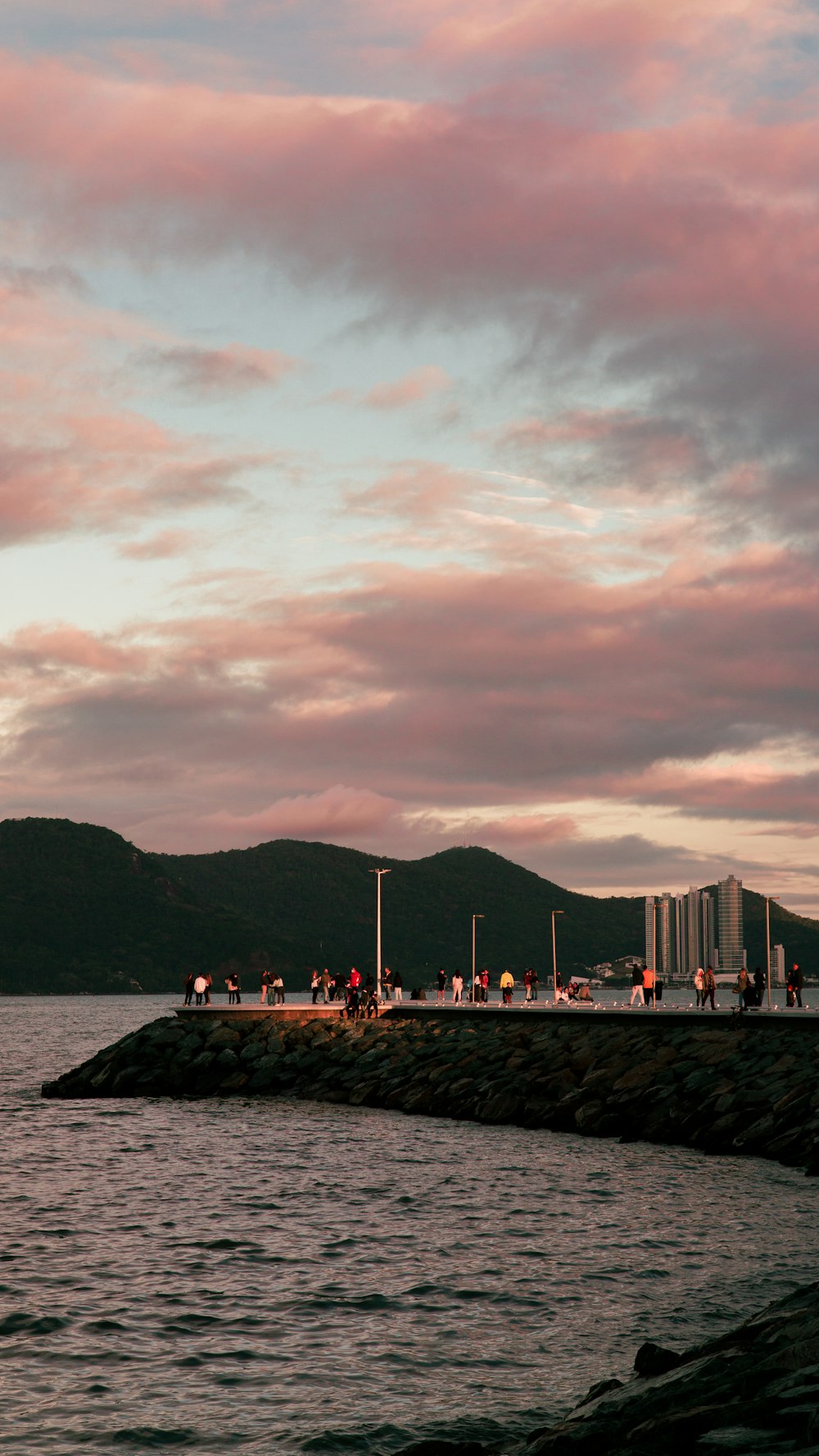 people walking on the beach during sunset