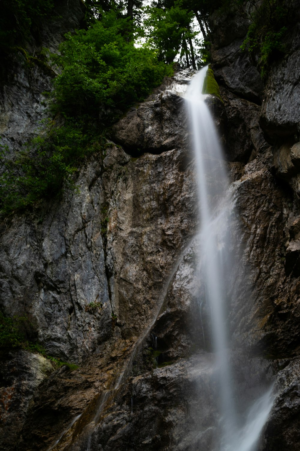 waterfalls on rocky mountain during daytime