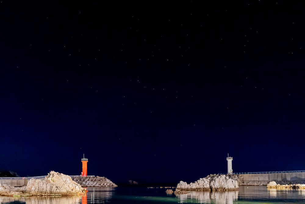 white concrete building near body of water during night time