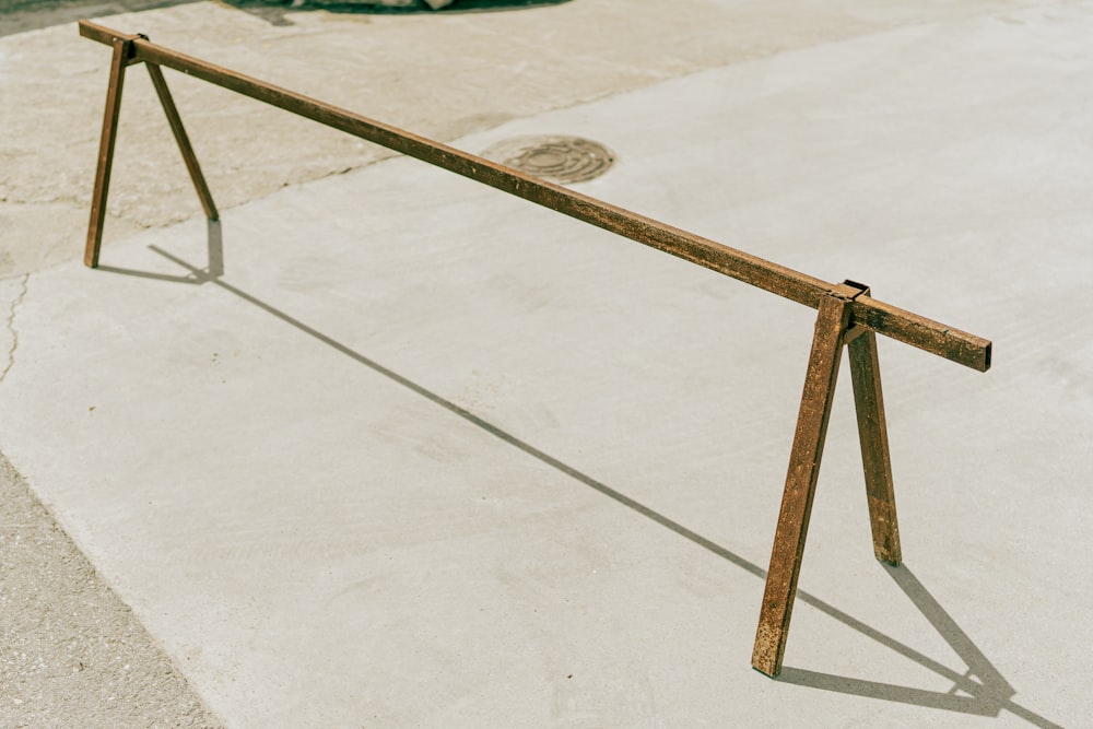 brown wooden stand on white concrete floor