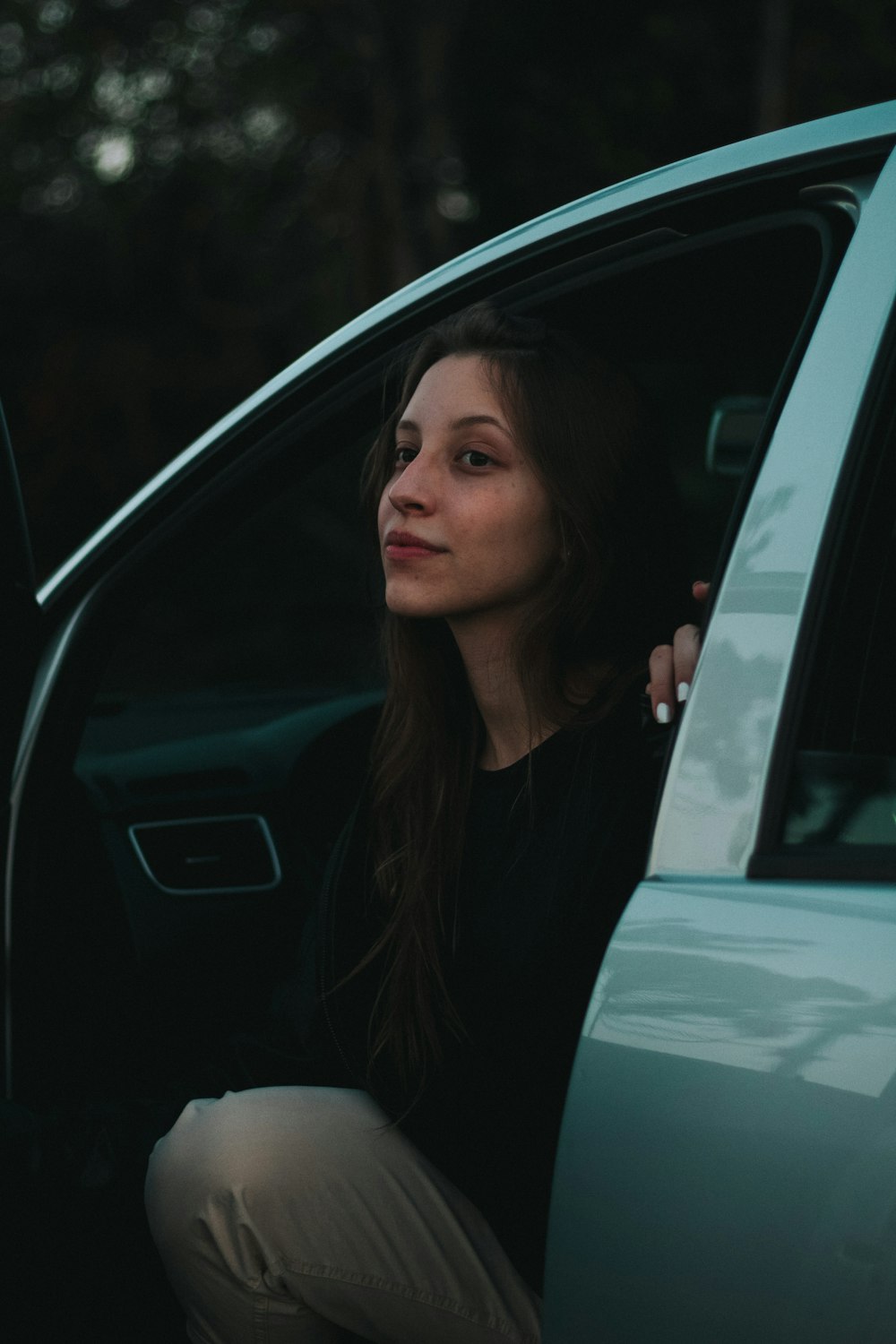 woman in black shirt sitting inside car