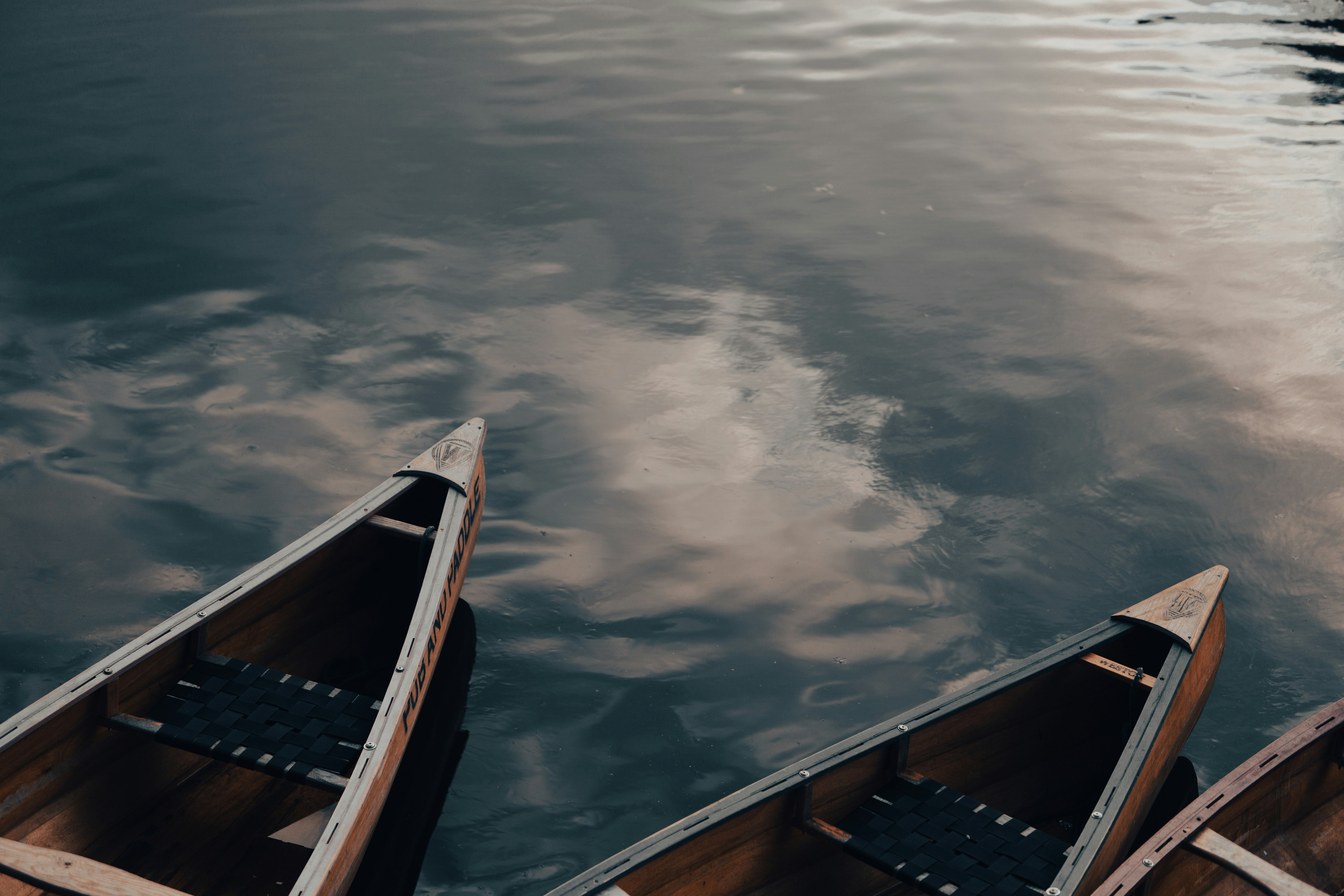 blue and black boat on body of water