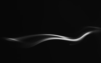 A flowing, ethereal white wave curves smoothly against a dark black background, creating a sense of movement and fluidity.