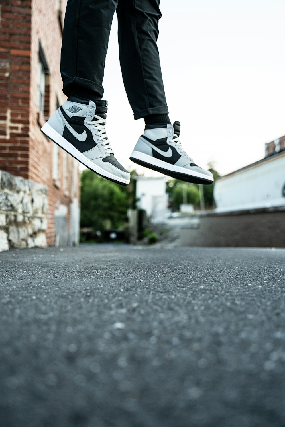 person in black and white nike sneakers