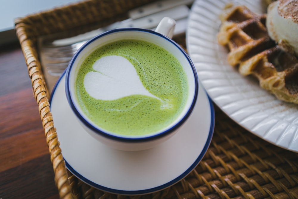 white ceramic mug with green liquid