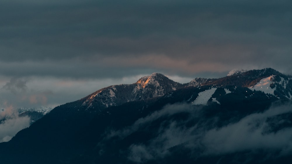 black and white mountains under gray sky