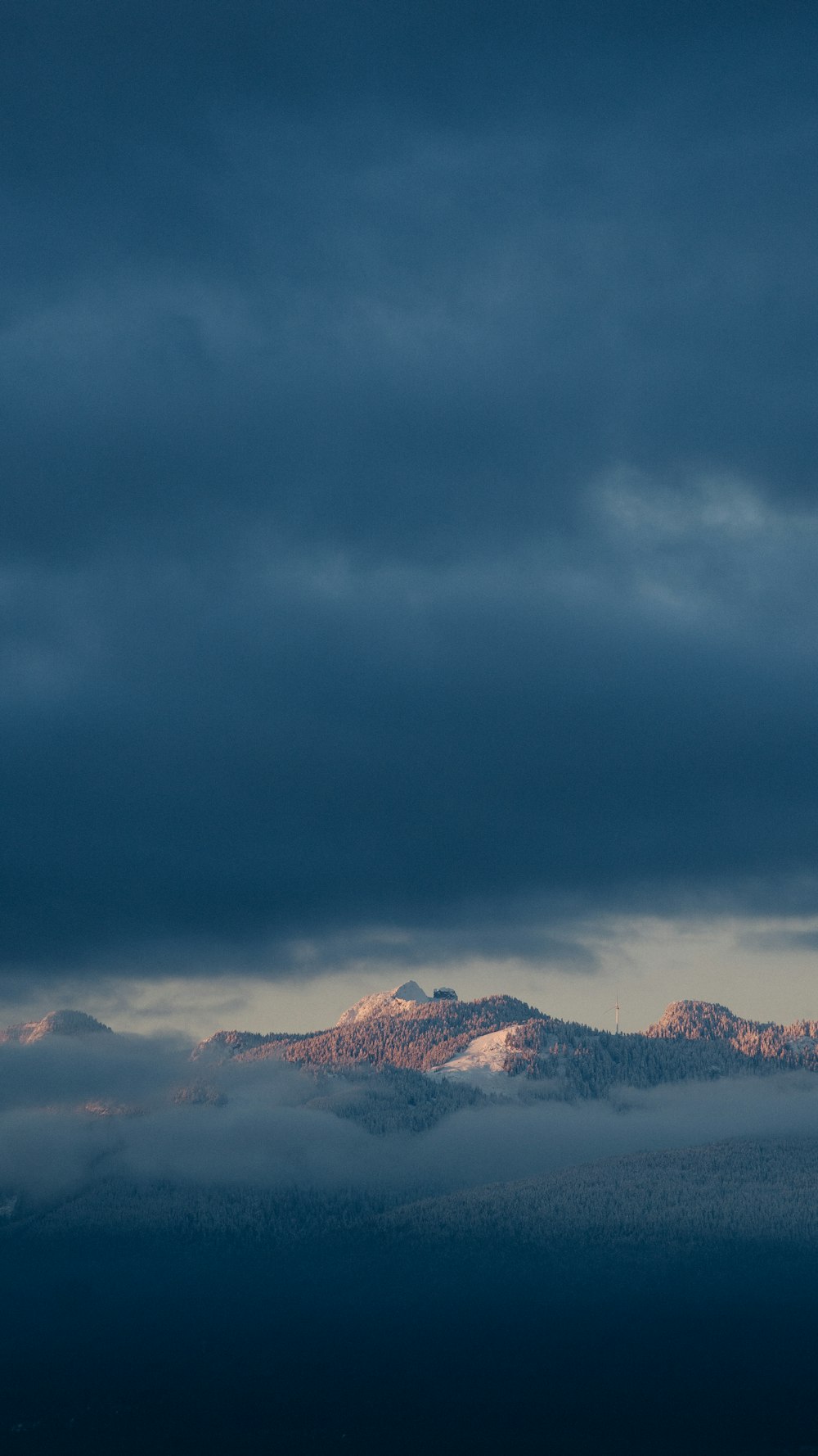 snow covered mountains under cloudy sky during daytime