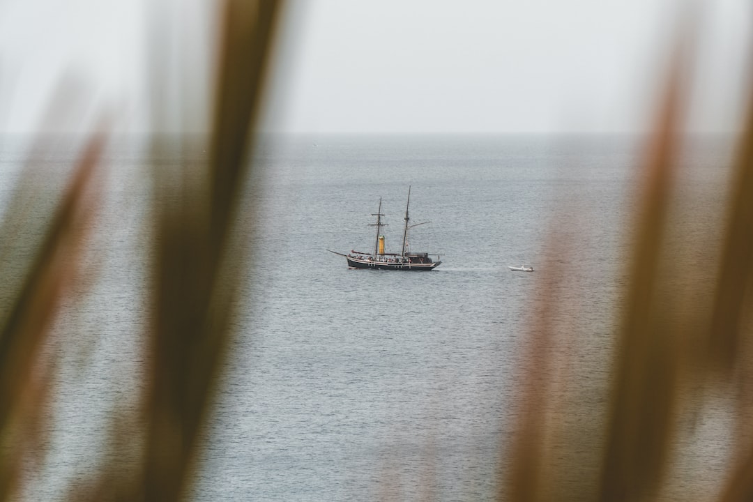 white boat on body of water during daytime