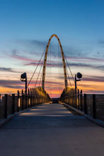 people walking on bridge during sunset