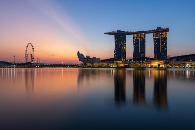 A stunning skyline view of Singapore at dusk with Marina Bay Sands and city lights glowing.