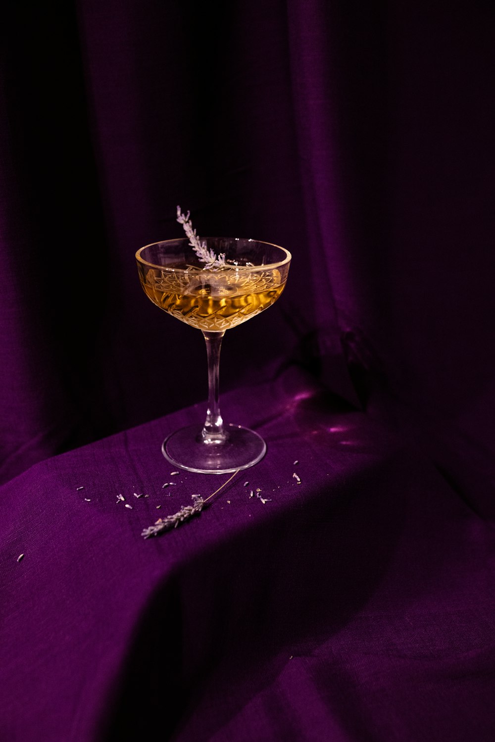 a glass filled with a drink sitting on top of a table