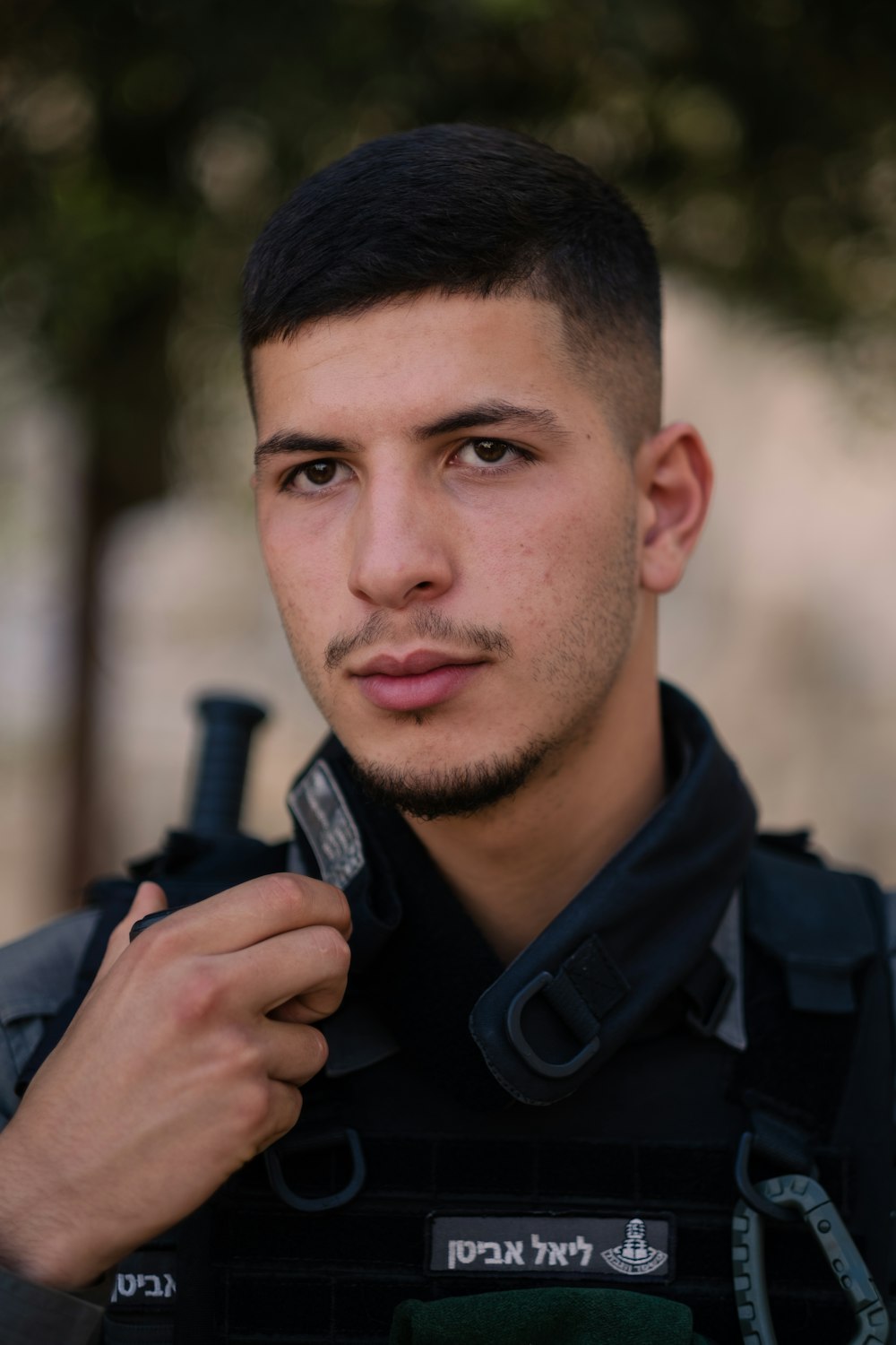 man in black jacket holding black smartphone