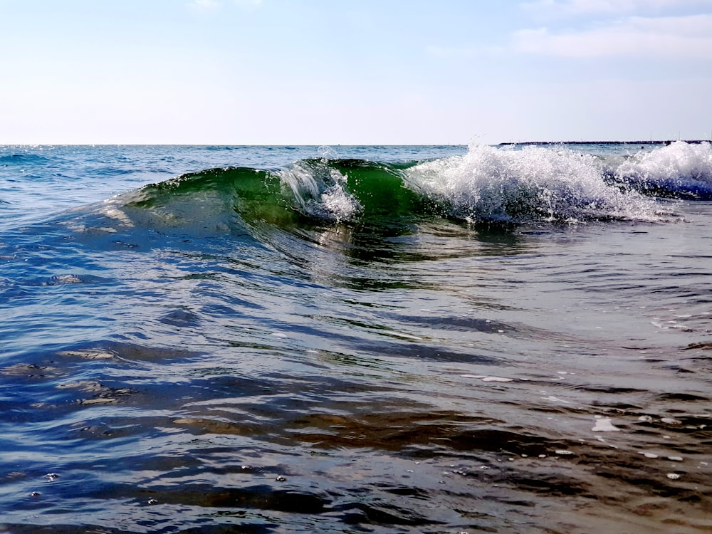 ocean waves crashing on shore during daytime