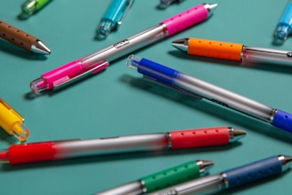 pink blue and green pens