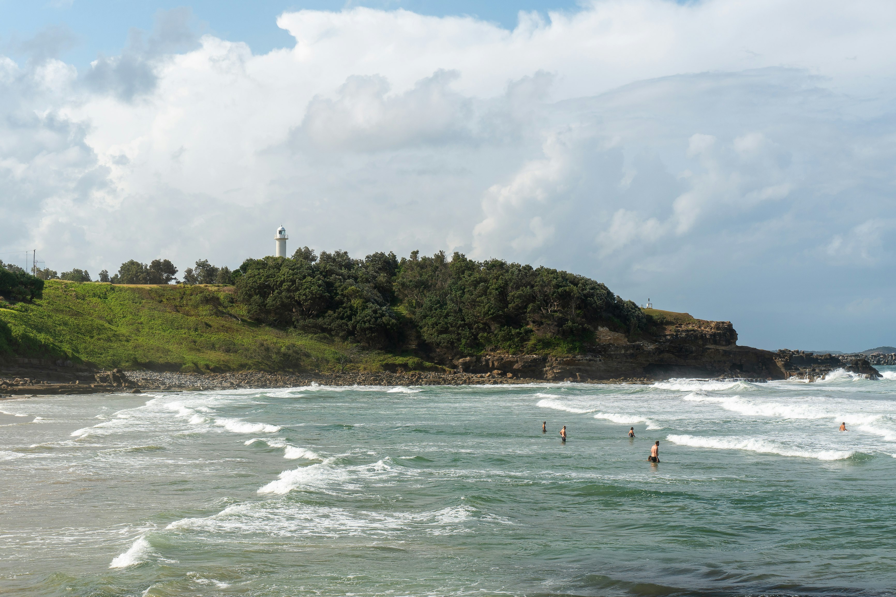 people surfing on sea waves during daytime