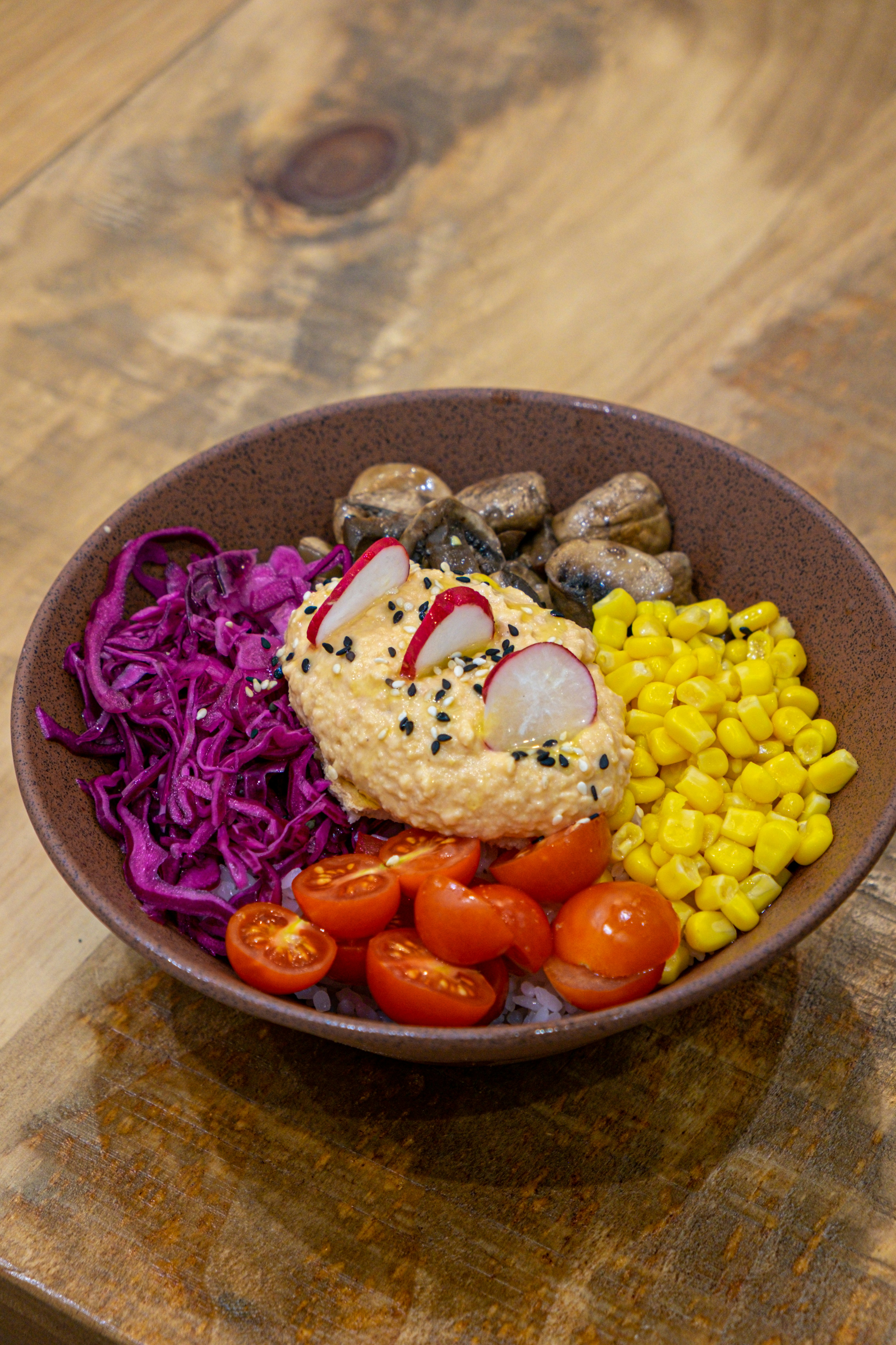 Vibrant Mediterranean grain bowl with golden saffron rice, grilled chicken, fresh hummus, and colorful roasted vegetables in bright airy setting",