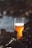 clear drinking glass with brown liquid on rock