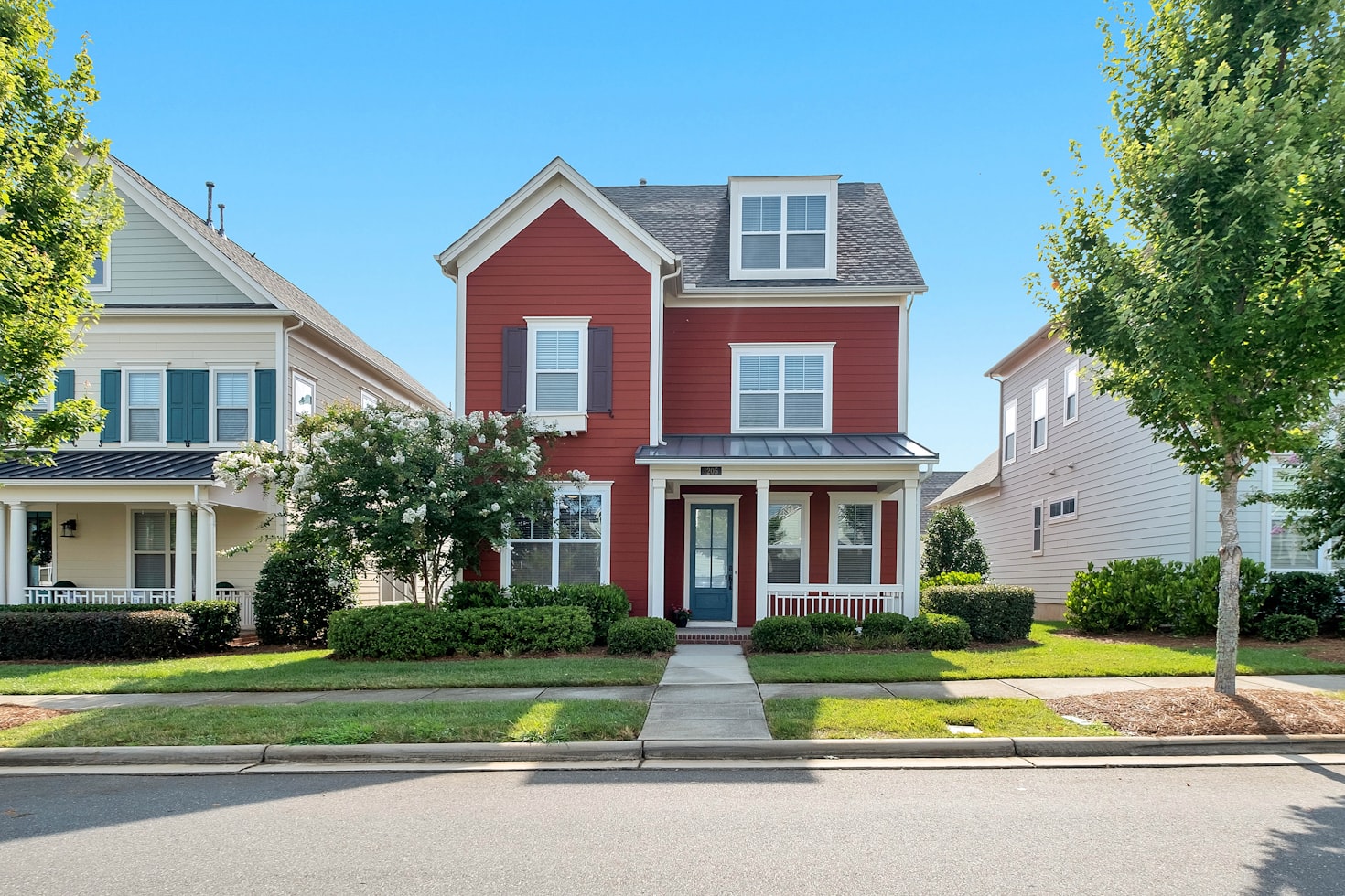  A Pretty Home with a Red Exterior and a Well-Maintained Front Yard in the Suburbs