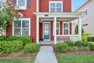red and white house with green grass lawn