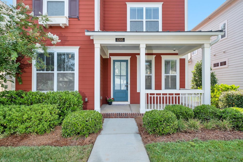 red and white house with green grass lawn