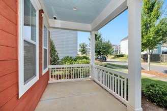 white wooden fence near green grass field during daytime