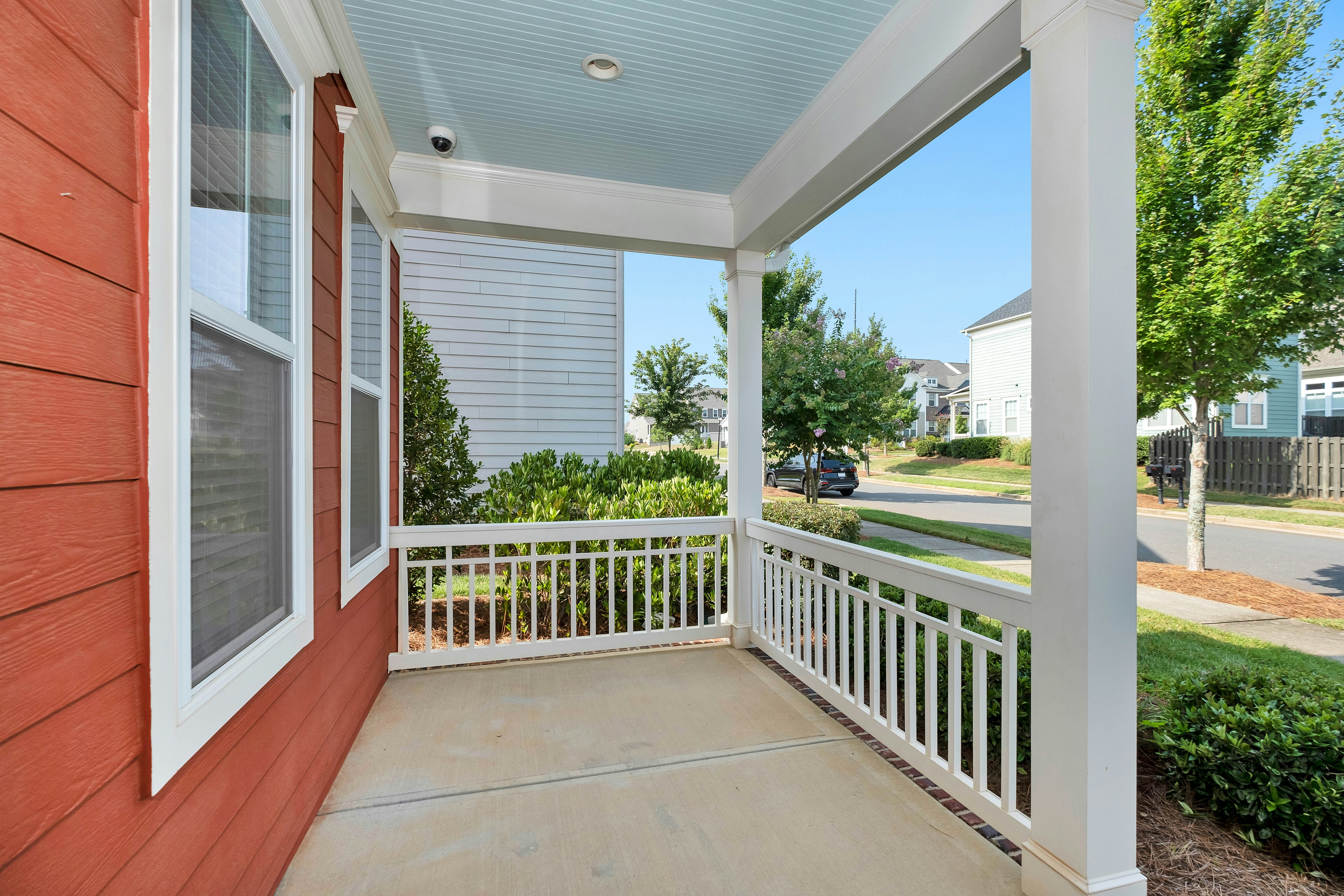 white wooden fence near green grass field during daytime