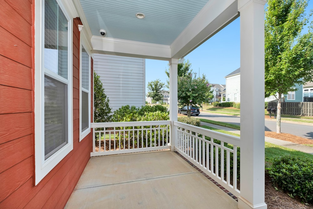 white wooden fence near green grass field during daytime