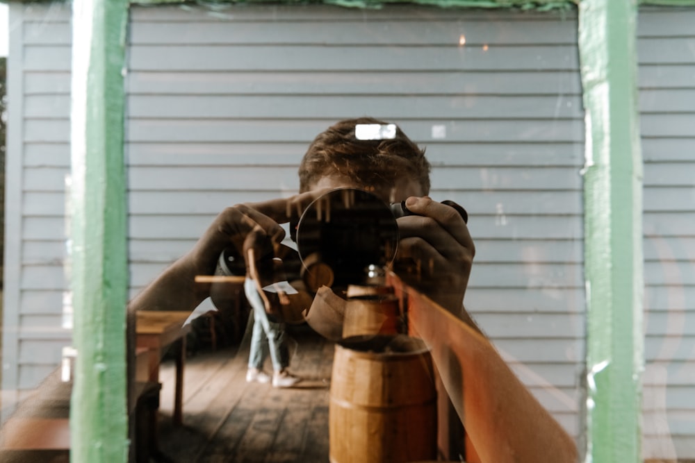 man taking photo of a man using a camera